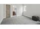 Neutral bedroom with large window, dark storage cube and carpeted floor at 3444 Navajo St # 10, Denver, CO 80211