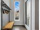 Modern entryway featuring a wooden bench and storage rack with a view of the outside at 3444 Navajo St # 10, Denver, CO 80211