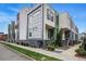 Modern townhome featuring multi-tone gray and white facade, brick accents, and landscaping at 3444 Navajo St # 10, Denver, CO 80211
