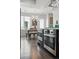 Modern kitchen featuring stainless steel appliances, a dining table, and sleek hardwood floors at 3444 Navajo St # 10, Denver, CO 80211