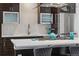 Modern kitchen featuring gas cooktop, stainless steel appliances, and white countertops at 3444 Navajo St # 10, Denver, CO 80211