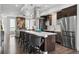 Open-concept kitchen features a large island, stainless appliances, and modern design at 3444 Navajo St # 10, Denver, CO 80211