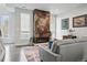 Comfortable living room features a unique fireplace, large windows and modern décor at 3444 Navajo St # 10, Denver, CO 80211