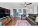 Cozy living room with a dark leather sofa, ceiling fan, built-in bar area, and vibrant area rug at 3444 Navajo St # 10, Denver, CO 80211