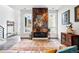 Bright living room with decorative fireplace and large windows, offering a modern design at 3444 Navajo St # 10, Denver, CO 80211