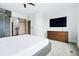 Bright main bedroom featuring a barn door and TV with a modern dresser at 3444 Navajo St # 10, Denver, CO 80211
