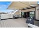 Rooftop deck featuring an awning, outdoor seating, and sliding glass doors leading to the interior at 3444 Navajo St # 10, Denver, CO 80211