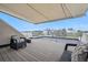 Rooftop deck with awning, patio furniture, and a breathtaking view of the city skyline at 3444 Navajo St # 10, Denver, CO 80211