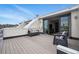 Spacious rooftop deck with lounge chairs, awning, and sliding glass doors for indoor/outdoor living at 3444 Navajo St # 10, Denver, CO 80211