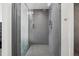 Walk-in shower with gray tile and glass enclosure, showcasing modern fixtures and a sleek design at 3444 Navajo St # 10, Denver, CO 80211