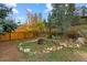 Tranquil backyard featuring a fire pit surrounded by decorative rocks and foliage, creating a cozy outdoor retreat at 26095 Columbine Trl, Kittredge, CO 80457