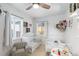 Sun-lit bedroom features two beds, whimsical decor, and ample natural light, creating a warm and inviting space at 26095 Columbine Trl, Kittredge, CO 80457