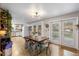 Bright dining room features wood floors, a large table and access to outdoor patio at 26095 Columbine Trl, Kittredge, CO 80457