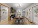 Bright dining room features wood floors, a large table and access to outdoor patio at 26095 Columbine Trl, Kittredge, CO 80457