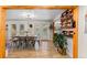 Dining room features wood floors, modern light fixture, and backyard view through glass doors at 26095 Columbine Trl, Kittredge, CO 80457