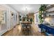 Bright dining room opens to kitchen and features wood floors and access to outdoor patio at 26095 Columbine Trl, Kittredge, CO 80457