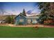 Charming single Gathering home with a beautiful lawn, garden, and stone patio at 26095 Columbine Trl, Kittredge, CO 80457
