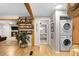 Hallway area with laundry area and a wood wine rack, with view into the main bedroom at 26095 Columbine Trl, Kittredge, CO 80457