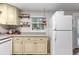 Kitchen featuring ample cabinet space, granite countertops, a white refrigerator, and fruit basket at 26095 Columbine Trl, Kittredge, CO 80457