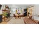 Inviting living room boasts a stone fireplace, hardwood floors and comfortable leather furniture at 26095 Columbine Trl, Kittredge, CO 80457