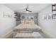 Calm main bedroom featuring soft grey walls, a cozy bed, floating shelves, and natural lighting at 26095 Columbine Trl, Kittredge, CO 80457