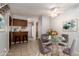 Virtually staged dining area with a glass table and four grey chairs at 1711 S Blackhawk Way # D, Aurora, CO 80012