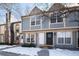 Two-story townhome with gray siding and brick chimney at 1711 S Blackhawk Way # D, Aurora, CO 80012