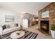 Living room with stone fireplace and staged furniture at 1711 S Blackhawk Way # D, Aurora, CO 80012