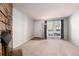 Bright living room with stone fireplace, large window, and neutral carpeting at 1711 S Blackhawk Way # D, Aurora, CO 80012