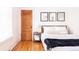 Cozy bedroom with hardwood floors, a comfortable bed, and minimalist decor at 3445 N Clay St, Denver, CO 80211