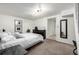 A cozy carpeted bedroom with a black dresser and neutral decor at 3445 N Clay St, Denver, CO 80211