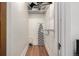 A functional walk-in closet with shelving, an ironing board, and hardwood floors at 3445 N Clay St, Denver, CO 80211