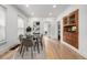Elegant dining area featuring a glass table, modern chairs, and hardwood floors at 3445 N Clay St, Denver, CO 80211