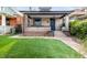 Charming brick home featuring a well-manicured lawn and covered front porch at 3445 N Clay St, Denver, CO 80211