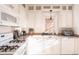 Bright kitchen featuring white cabinets and tile backsplash at 3445 N Clay St, Denver, CO 80211
