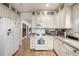 Bright kitchen features white cabinets, granite countertops, and stainless steel appliances at 3445 N Clay St, Denver, CO 80211