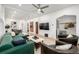 Bright living room with a modern green sectional, hardwood floors, and stylish furniture at 3445 N Clay St, Denver, CO 80211