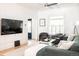 Bright living room with comfortable seating, a large TV, and hardwood floors at 3445 N Clay St, Denver, CO 80211