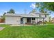 Backyard view of the home, featuring a covered patio and well-maintained lawn at 4525 S Cole Ct, Morrison, CO 80465