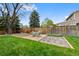 Spacious backyard with a seating area, lush lawn, and a wooden fence at 4525 S Cole Ct, Morrison, CO 80465