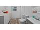 A bright laundry area and bathroom featuring modern gray accents at 4525 S Cole Ct, Morrison, CO 80465
