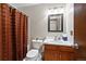 Bathroom featuring a wood vanity, a mirror, and a shower with a brown curtain at 4525 S Cole Ct, Morrison, CO 80465