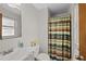 Bathroom with a colorful shower curtain and white porcelain fixtures at 4525 S Cole Ct, Morrison, CO 80465