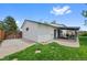 Home exterior with a covered patio, green lawn, and a fenced yard at 4525 S Cole Ct, Morrison, CO 80465