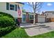 Inviting entryway featuring a brick facade, bench seating, and manicured landscaping at 4525 S Cole Ct, Morrison, CO 80465