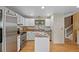 Updated kitchen with stainless steel appliances, white cabinets, and wood flooring at 4525 S Cole Ct, Morrison, CO 80465