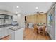 Eat-in kitchen features an island and a wood-accented dining area at 4525 S Cole Ct, Morrison, CO 80465