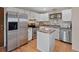 Bright kitchen with stainless steel appliances, granite countertops, and wood floors at 4525 S Cole Ct, Morrison, CO 80465
