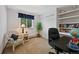 Bright office with built-in shelves, desk, and a comfortable chair by the window at 4525 S Cole Ct, Morrison, CO 80465