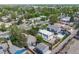 An aerial view displays a residential neighborhood showcasing the home's roof and backyard surrounded by lush greenery at 1765 Xenia St, Denver, CO 80220